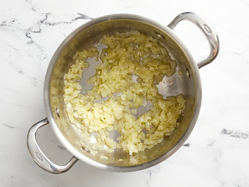 Saut&eacute;ed onion and garlic in a saucepot.