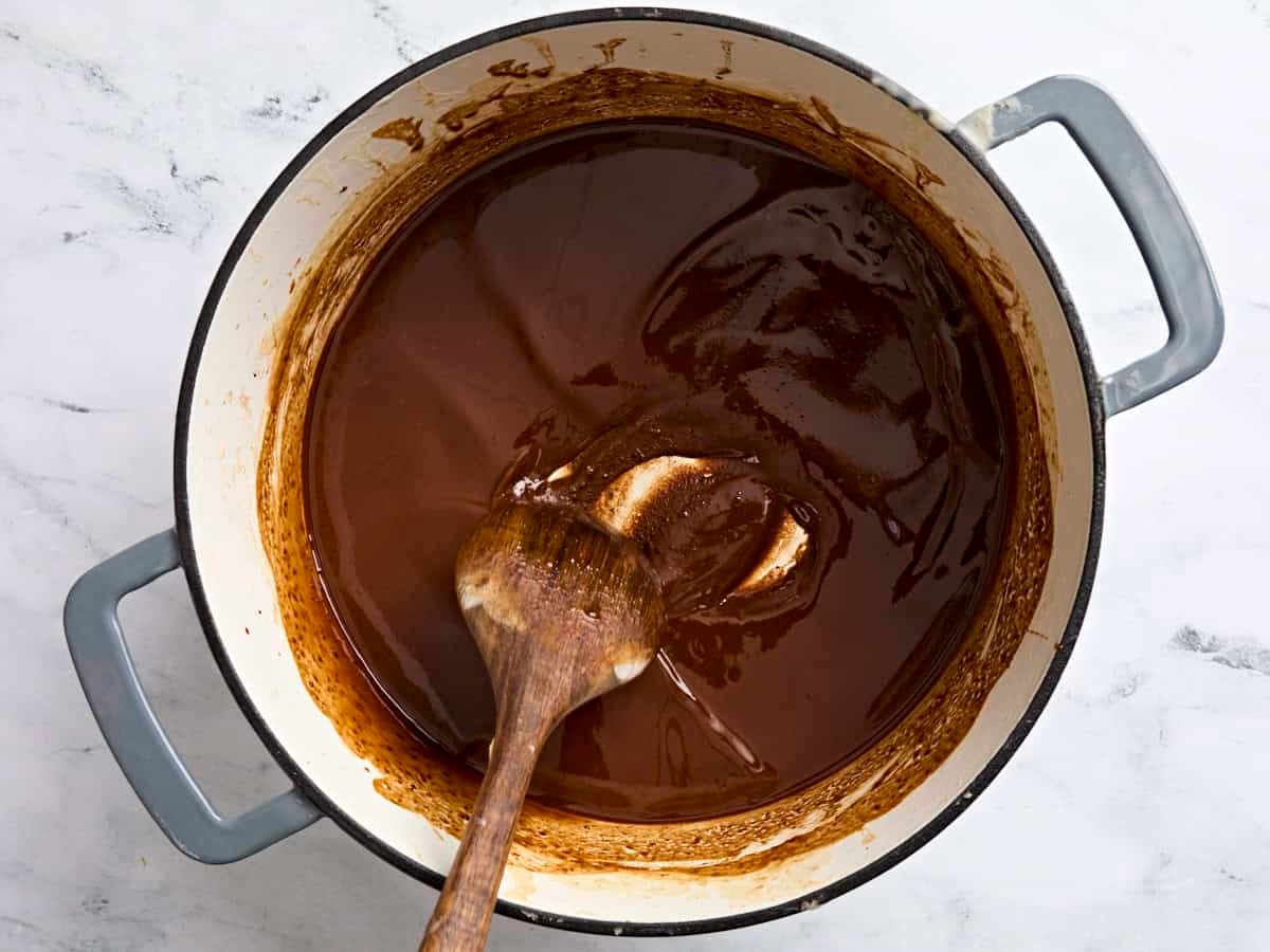 A very dark brown roux in a pot for gumbo.