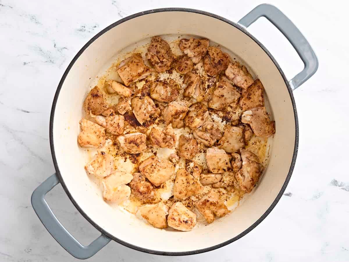 Browned chicken in a skillet.