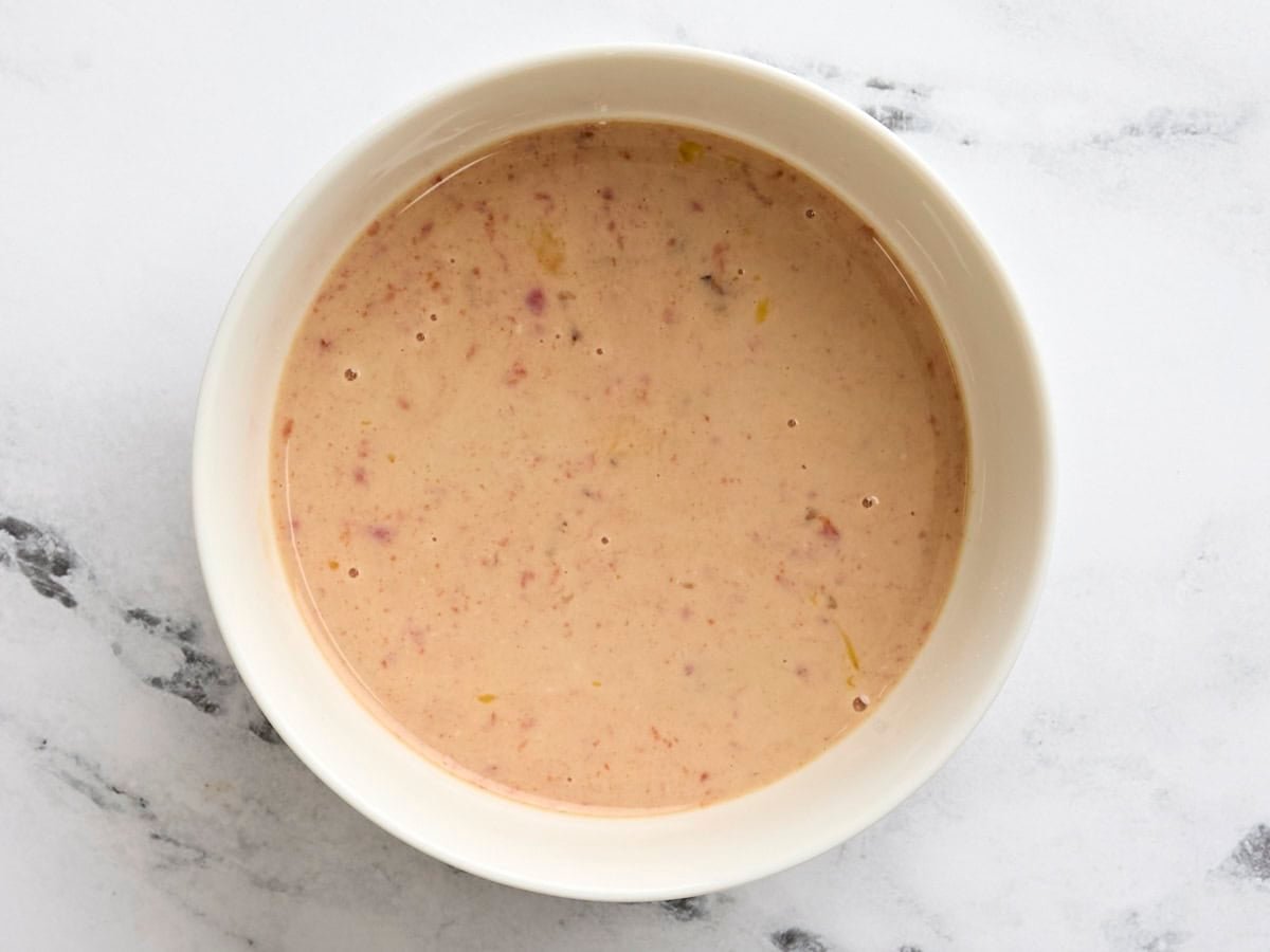 Milk, egg, and ketchup mixed together in a bowl.