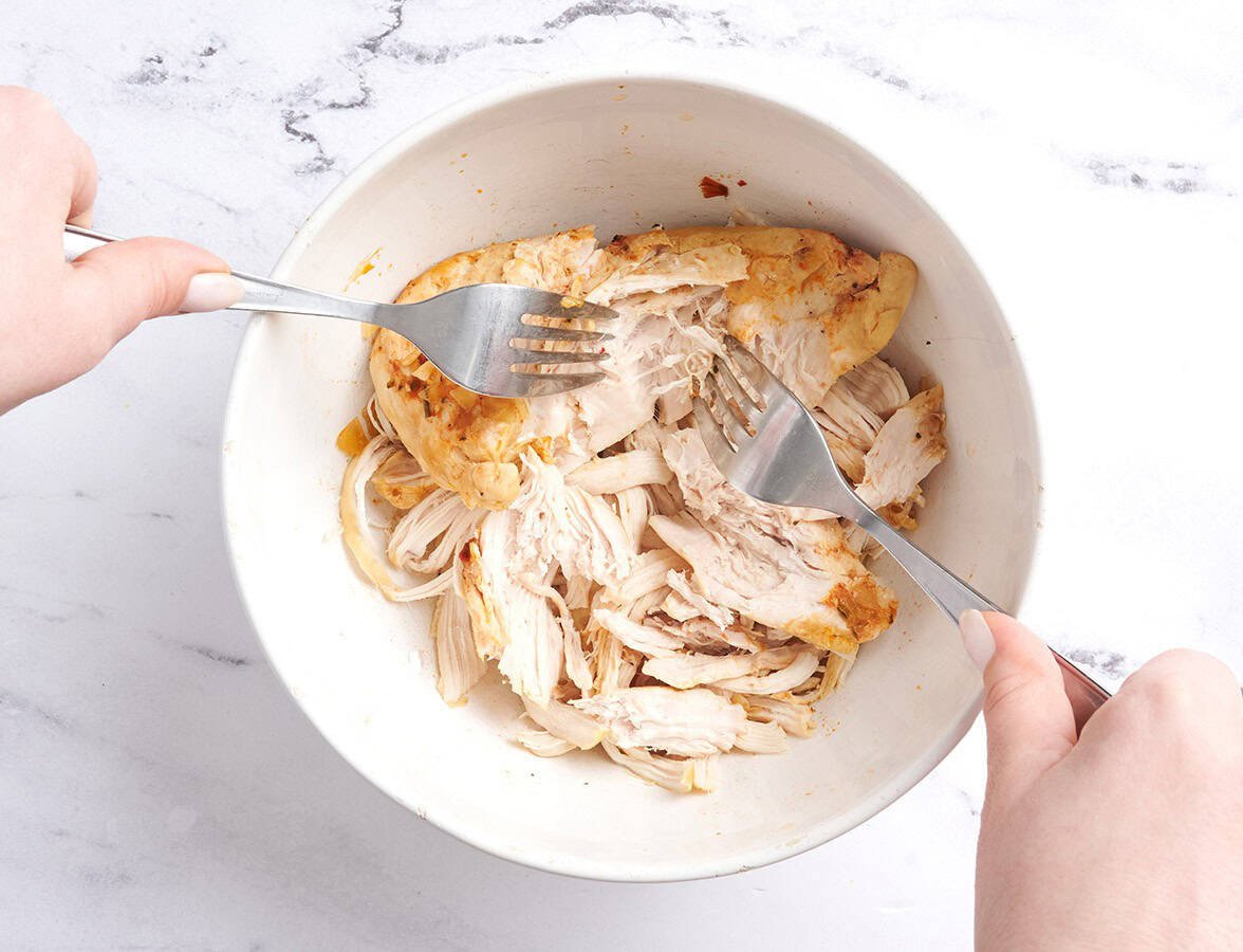 shredding chicken with two forks for marry me chicken soup