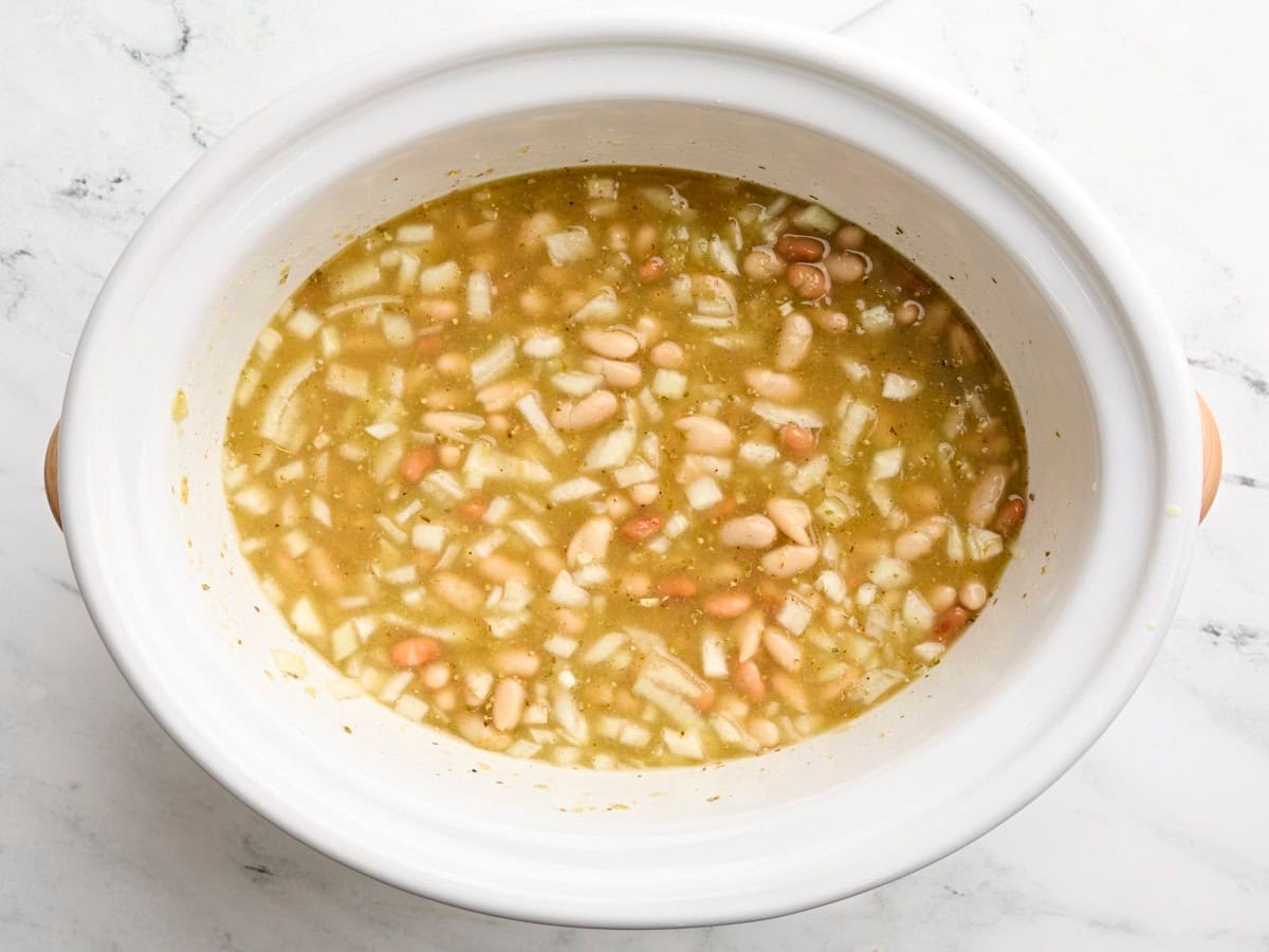Slow cooker white chicken chili in a crockpot before cooking.