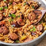 Side view of a skillet full of Cajun Sausage and Rice