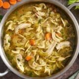 Overhead view of a pot of homemade chicken noodle soup.