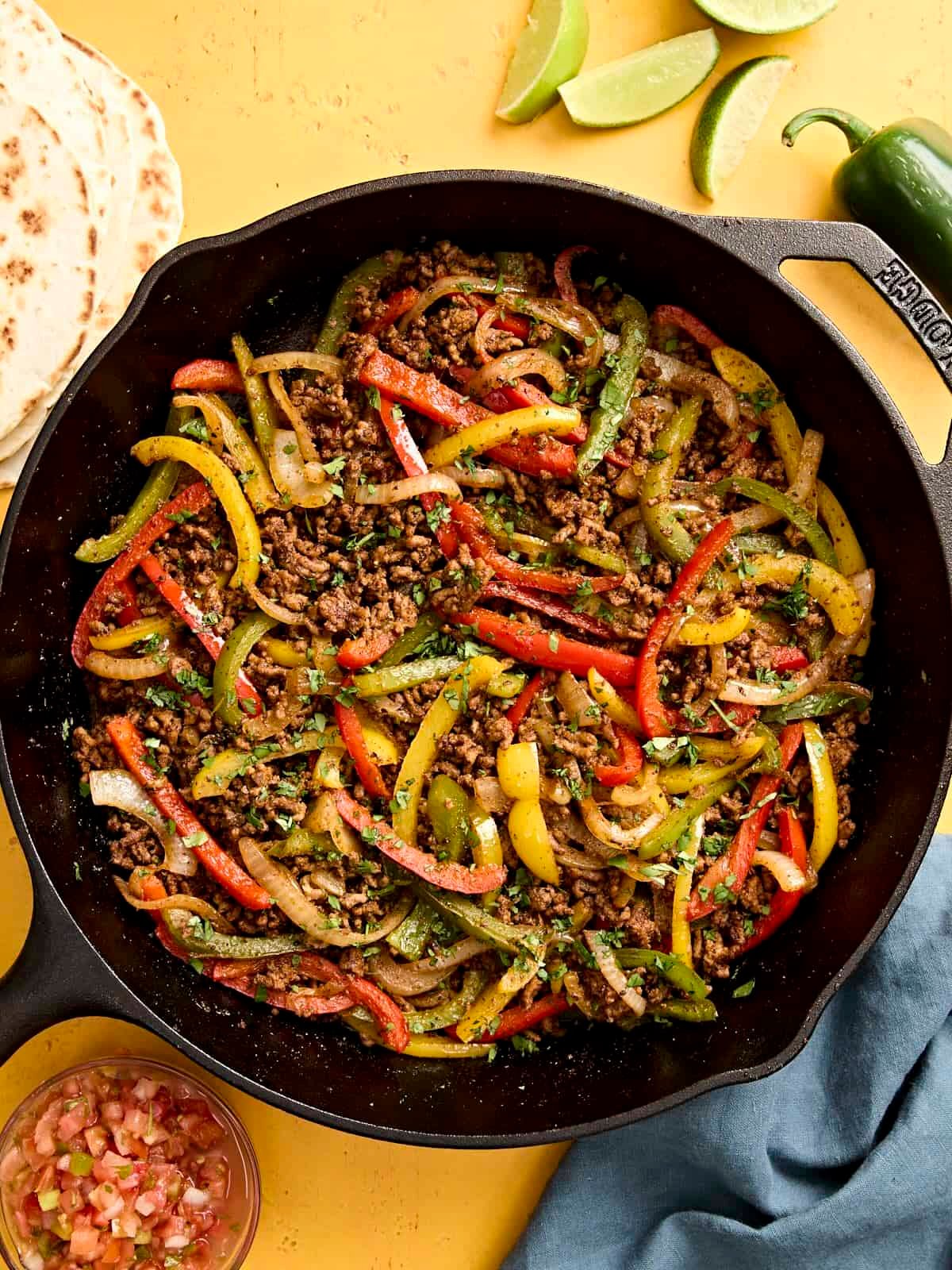Overhead view of ground beef fajitas filling in a skillet.