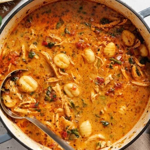 Pot of marry me chicken soup with a ladle in it.