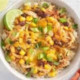 Overhead view of chicken bowls with tacos in a white bowl.