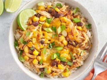 Overhead view of chicken bowls with tacos in a white bowl.
