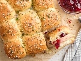 Overhead view of turkey sliders, with one roll turned on its side.